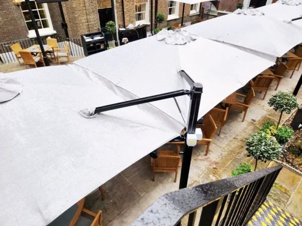 Malaga Duo cantilever parasols in the courtyard of The In & Out Club, London